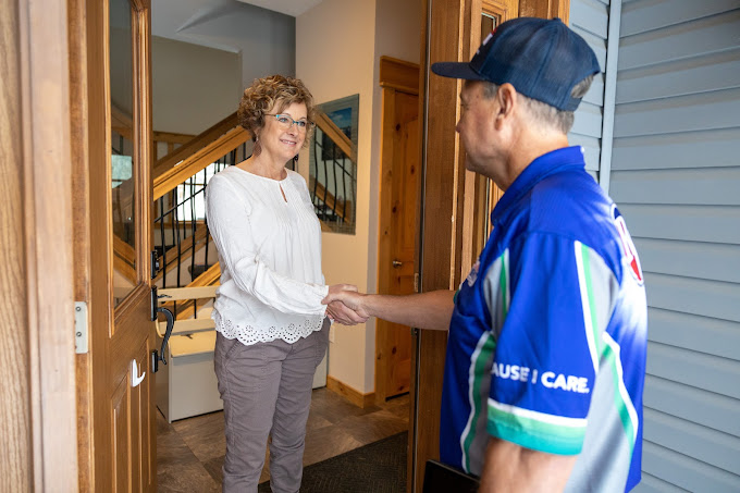 Reliable Comfort technician greeting homeowner