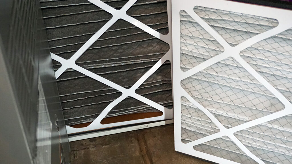 comparison of a new and old air filter. Old is dark grey and new is white