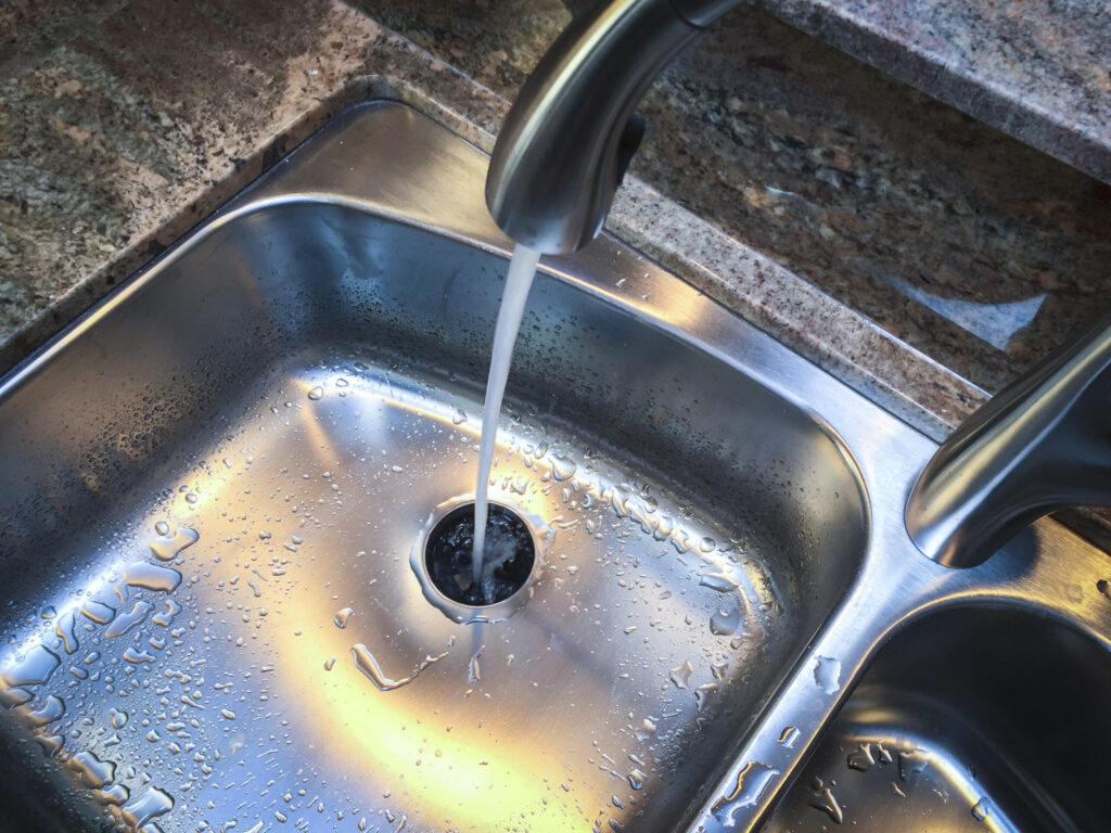 Water down the drain of kitchen sink