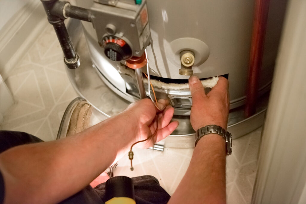 Technician performing routine water heater maintenance 